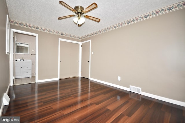 8922 Brous Ave, Philadelphia, PA 19152 - unfurnished bedroom featuring baseboards, wood finished floors, a textured ceiling, a sink, and ensuite bath