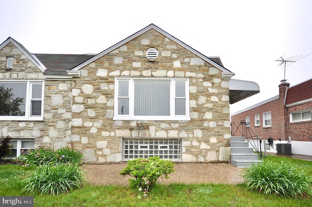8922 Brous Ave, Philadelphia, PA 19152 - view of side of property featuring stone siding and cooling unit
