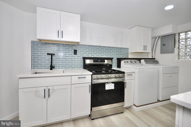 8922 Brous Ave, Philadelphia, PA 19152 - kitchen featuring stainless steel range with gas cooktop, separate washer and dryer, electric panel, a sink, and light countertops