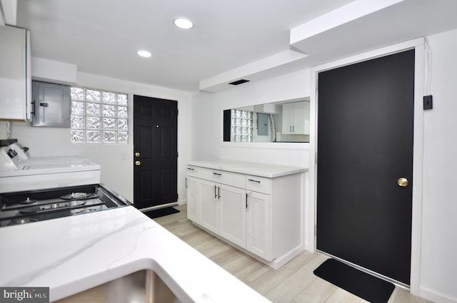 8922 Brous Ave, Philadelphia, PA 19152 - kitchen featuring separate washer and dryer, light wood-style floors, recessed lighting, and white cabinets