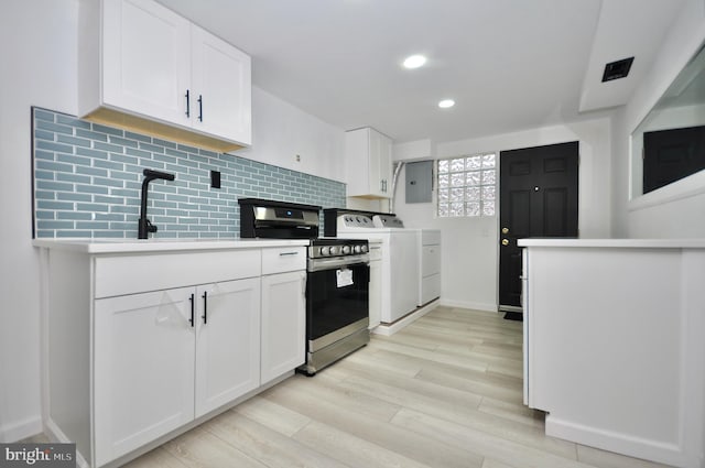 8922 Brous Ave, Philadelphia, PA 19152 - kitchen with stainless steel electric range, washing machine and clothes dryer, electric panel, light wood-style floors, and backsplash