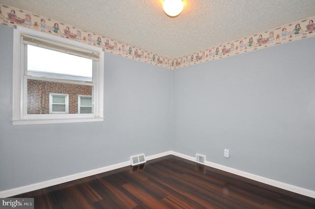 8922 Brous Ave, Philadelphia, PA 19152 - spare room with dark wood-type flooring, baseboards, and a textured ceiling