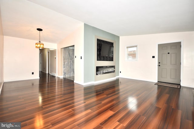 8922 Brous Ave, Philadelphia, PA 19152 - unfurnished living room featuring a chandelier, dark wood-style floors, and baseboards