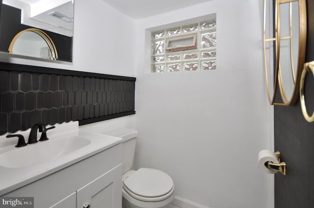 8922 Brous Ave, Philadelphia, PA 19152 - bathroom with toilet, vanity, tasteful backsplash, and baseboards