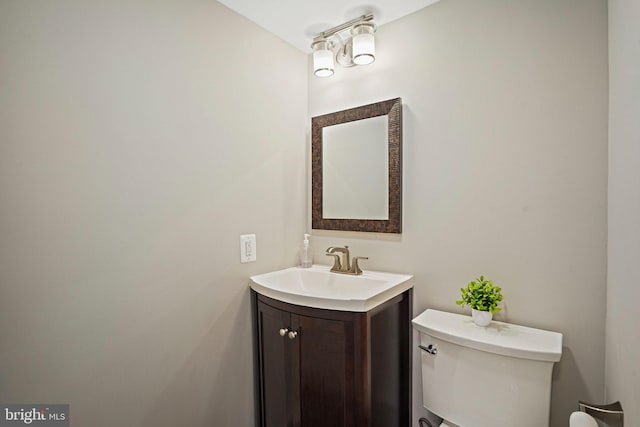 half bathroom featuring toilet and vanity