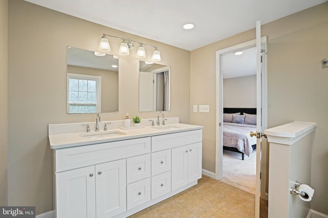 bathroom with baseboards, double vanity, connected bathroom, recessed lighting, and tile patterned flooring