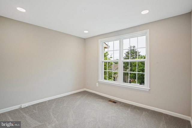 carpeted empty room featuring baseboards and recessed lighting