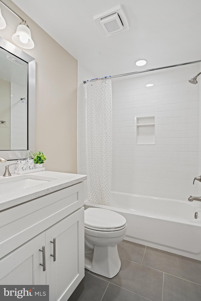 full bath featuring tile patterned floors, toilet, shower / bath combo with shower curtain, vanity, and recessed lighting
