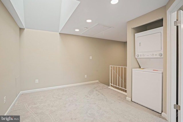 clothes washing area featuring attic access, stacked washing machine and dryer, recessed lighting, carpet, and baseboards