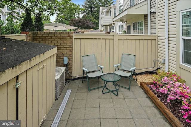view of patio featuring fence and central air condition unit