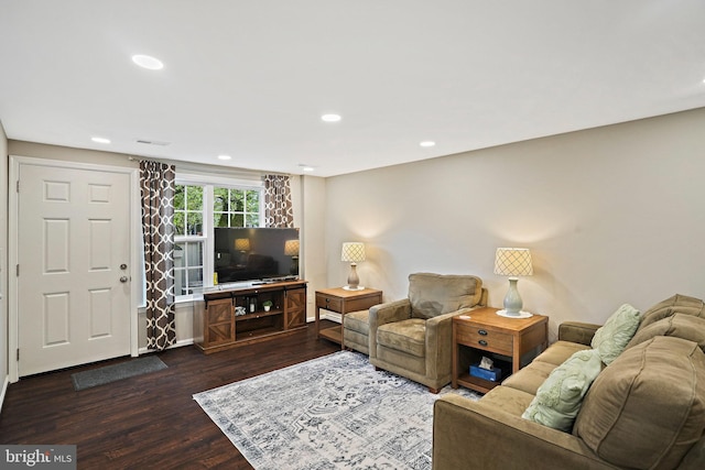living area featuring dark wood-style flooring and recessed lighting