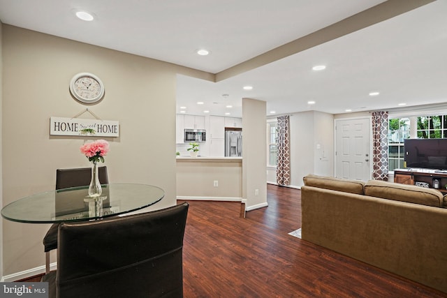 dining space with dark wood-style flooring, recessed lighting, and baseboards