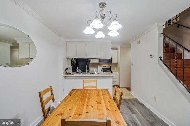 dining room with a chandelier, ornamental molding, stairs, baseboards, and light wood-style floors