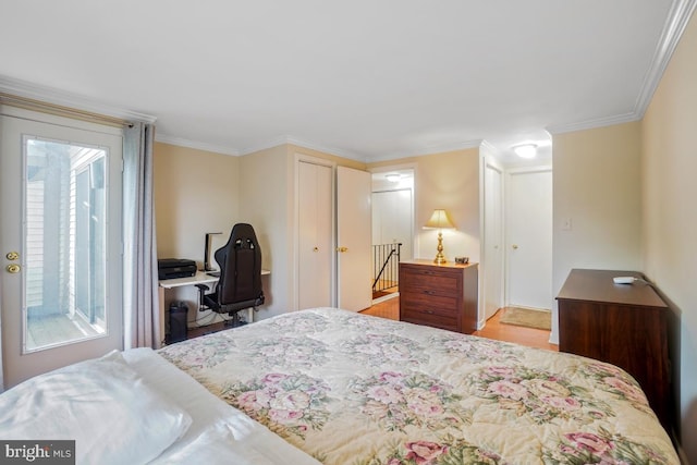 bedroom featuring wood finished floors and ornamental molding