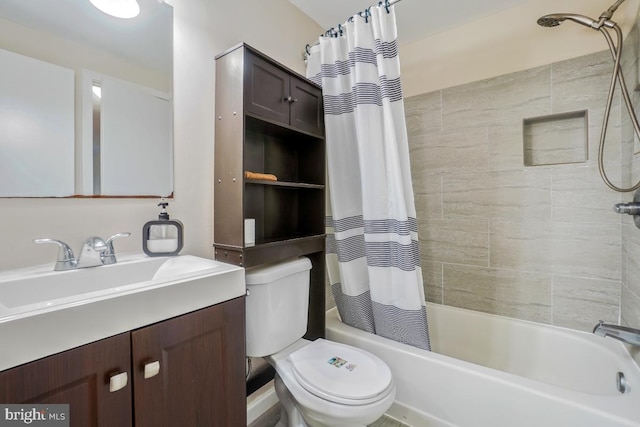 bathroom featuring toilet, shower / bath combo with shower curtain, and vanity
