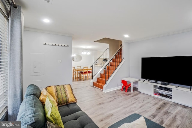 living room featuring ornamental molding, stairs, wood finished floors, a chandelier, and recessed lighting