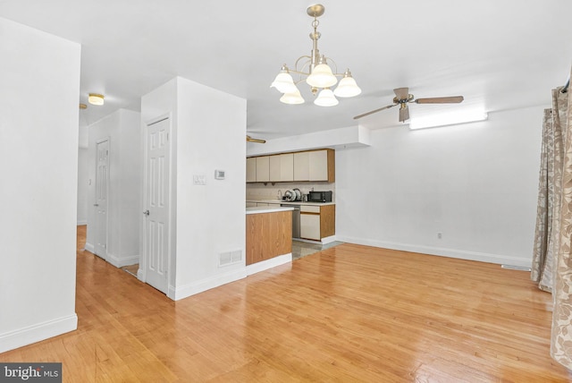 643 Saint Anthony Ln, Upper Darby, PA 19082 - kitchen featuring light wood-style floors, ceiling fan, baseboards, light countertops, and hanging light fixtures