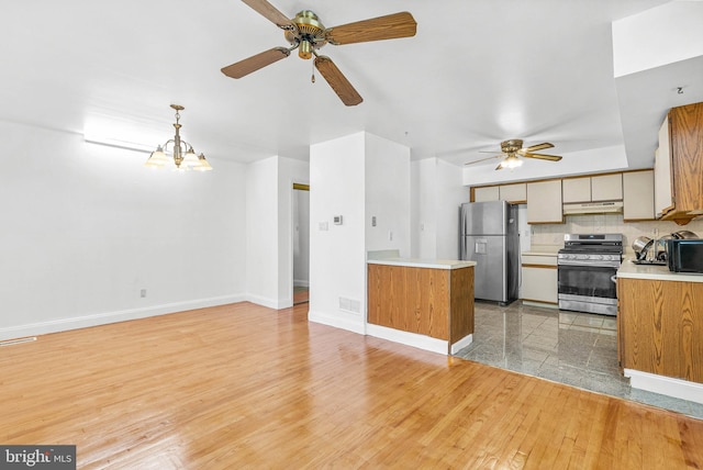 643 Saint Anthony Ln, Upper Darby, PA 19082 - kitchen featuring appliances with stainless steel finishes, under cabinet range hood, ceiling fan, and light countertops