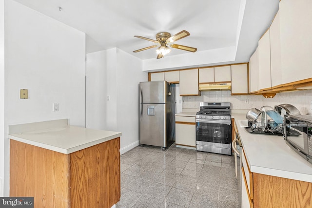 643 Saint Anthony Ln, Upper Darby, PA 19082 - kitchen with stainless steel appliances, under cabinet range hood, a ceiling fan, baseboards, and light countertops