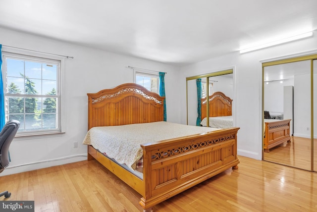 643 Saint Anthony Ln, Upper Darby, PA 19082 - bedroom featuring light wood finished floors, baseboards, and two closets