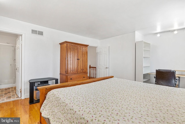 643 Saint Anthony Ln, Upper Darby, PA 19082 - bedroom with light wood-style flooring, rail lighting, and baseboards