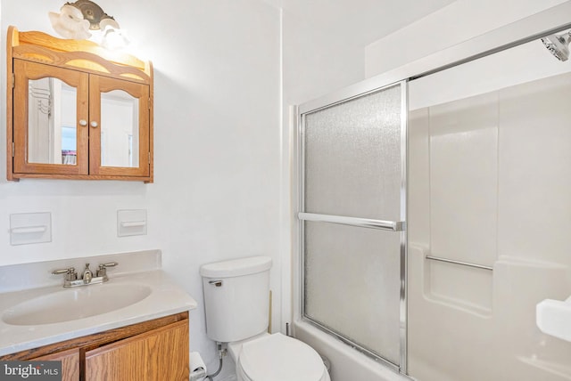 643 Saint Anthony Ln, Upper Darby, PA 19082 - bathroom featuring toilet, vanity, and combined bath / shower with glass door
