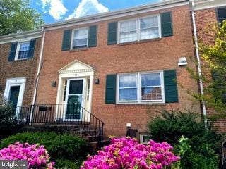 townhome / multi-family property featuring brick siding