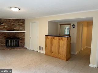 13 E Cliff St, Alexandria, VA 22301 - unfurnished living room with baseboards and a fireplace