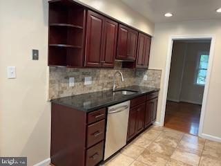 13 E Cliff St, Alexandria, VA 22301 - kitchen with stainless steel dishwasher, a sink, tasteful backsplash, dark countertops, and recessed lighting