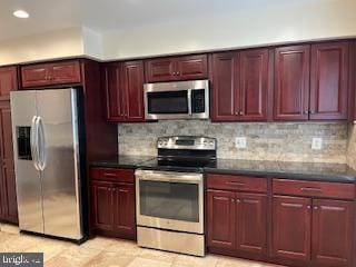 13 E Cliff St, Alexandria, VA 22301 - kitchen with appliances with stainless steel finishes, reddish brown cabinets, decorative backsplash, and recessed lighting