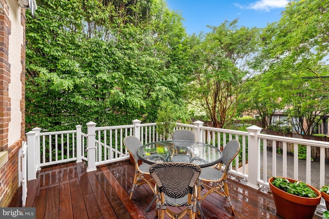 wooden terrace with outdoor dining space