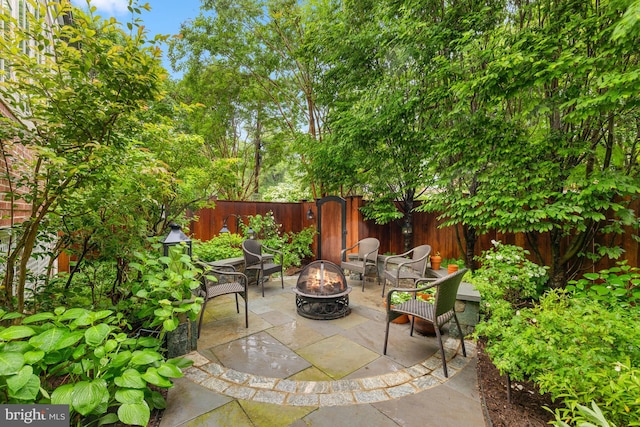 view of patio with a fire pit and a fenced backyard