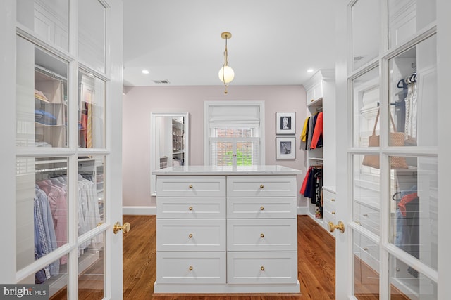spacious closet with wood finished floors