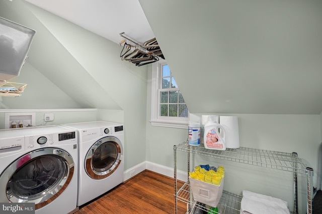 washroom with wood finished floors, separate washer and dryer, and baseboards