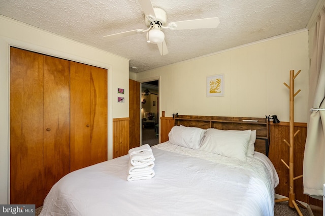 3432 Glendale Rd, Swanton, MD 21561 - carpeted bedroom featuring a textured ceiling, a closet, a wainscoted wall, ceiling fan, and crown molding