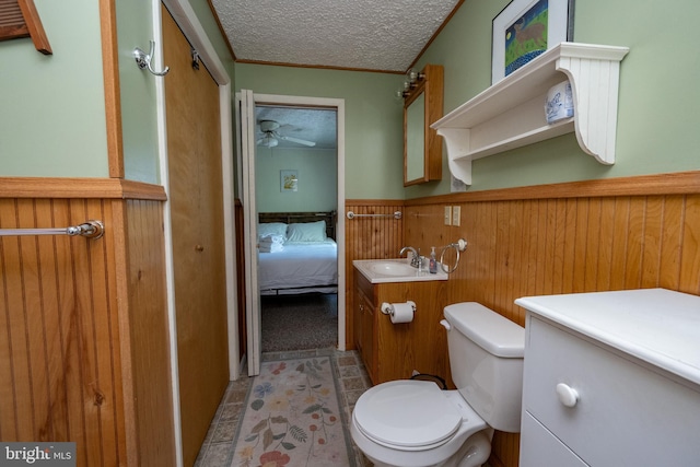 3432 Glendale Rd, Swanton, MD 21561 - bathroom with a ceiling fan, a textured ceiling, toilet, wainscoting, and vanity