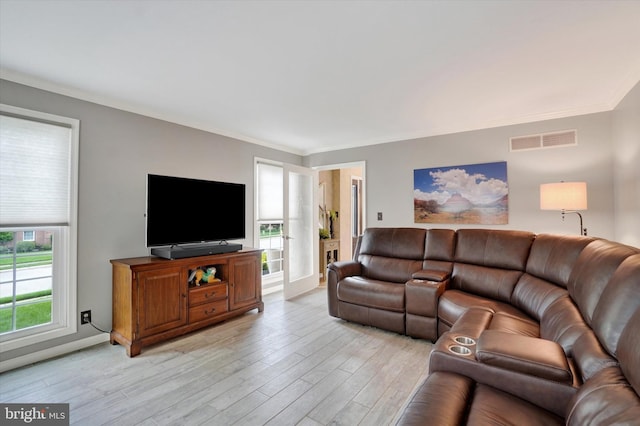 living room with crown molding and light wood finished floors