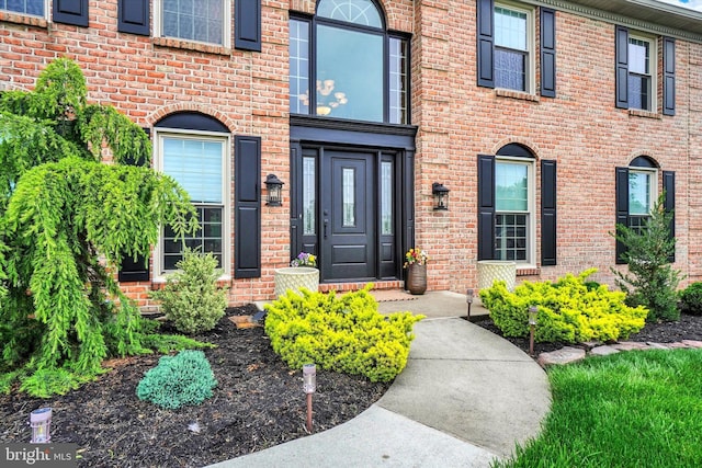 property entrance with brick siding