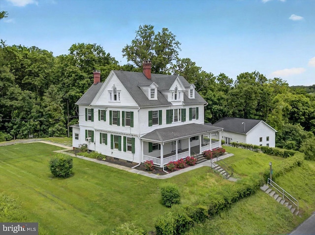 1 N Landvale St, York Haven, PA 17370 - view of front of property with covered porch, a chimney, a front lawn, and a forest view