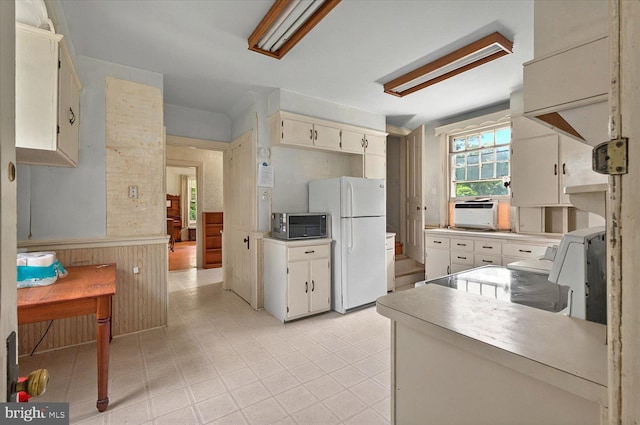 1 N Landvale St, York Haven, PA 17370 - kitchen featuring freestanding refrigerator, stainless steel microwave, a wainscoted wall, light countertops, and range