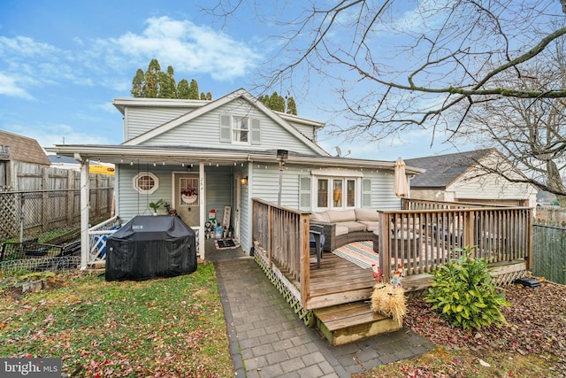 back of house with a fenced backyard and a wooden deck