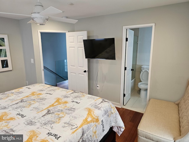 bedroom featuring dark wood-style flooring and ensuite bath
