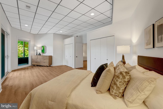 2200 Spinnaker Ct, Reston, VA 20191 - bedroom featuring access to exterior, wood finished floors, multiple closets, and baseboards