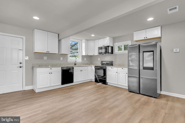 21 Mattingly Ave, Indian Head, MD 20640 - kitchen with black appliances, baseboards, light wood finished floors, white cabinets, and recessed lighting