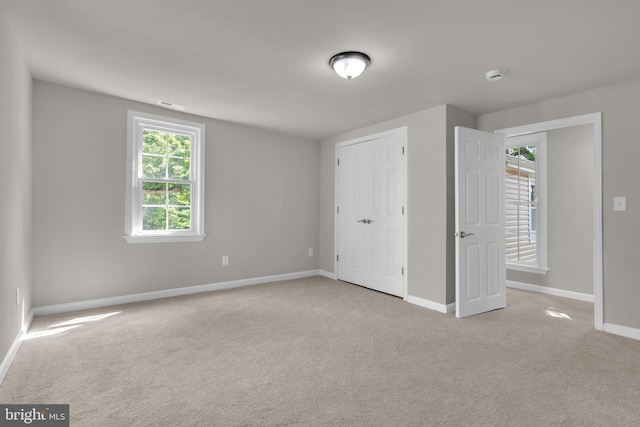 21 Mattingly Ave, Indian Head, MD 20640 - unfurnished bedroom with carpet, baseboards, multiple windows, and a closet