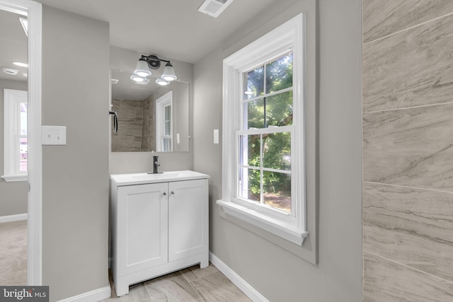 21 Mattingly Ave, Indian Head, MD 20640 - bathroom with baseboards, vanity, and marble look tiles