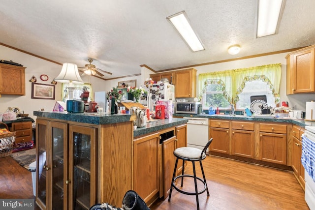 191 Youngs Dr, Front Royal, VA 22630 - kitchen with white appliances, crown molding, a center island, light wood finished floors, and a textured ceiling