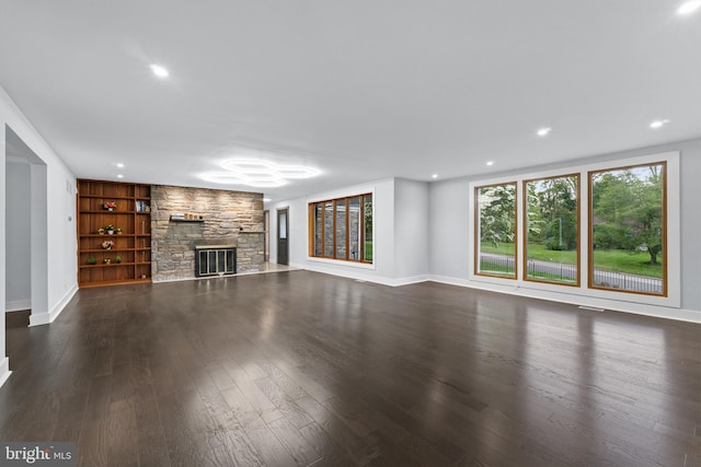 616 Webb Rd, Elkins Park, PA 19027 - unfurnished living room with a stone fireplace, dark wood finished floors, baseboards, recessed lighting, and built in features