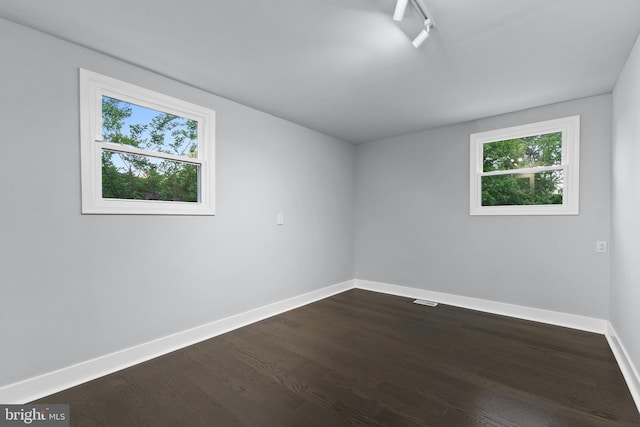 616 Webb Rd, Elkins Park, PA 19027 - empty room with baseboards, healthy amount of natural light, and dark wood finished floors