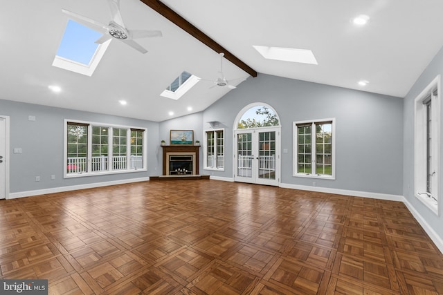 616 Webb Rd, Elkins Park, PA 19027 - unfurnished living room featuring a skylight, a ceiling fan, baseboards, beamed ceiling, and plenty of natural light